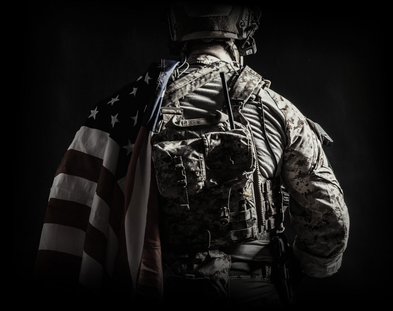 Soldier Wearing a United States flag on their left shoulder with their back turned